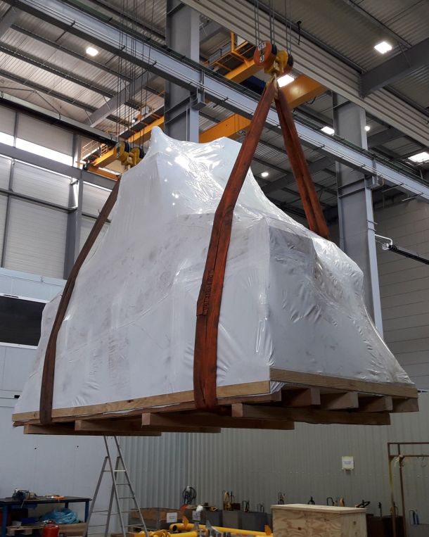 Industrieanlage in Folie verpackt hängt am Kran